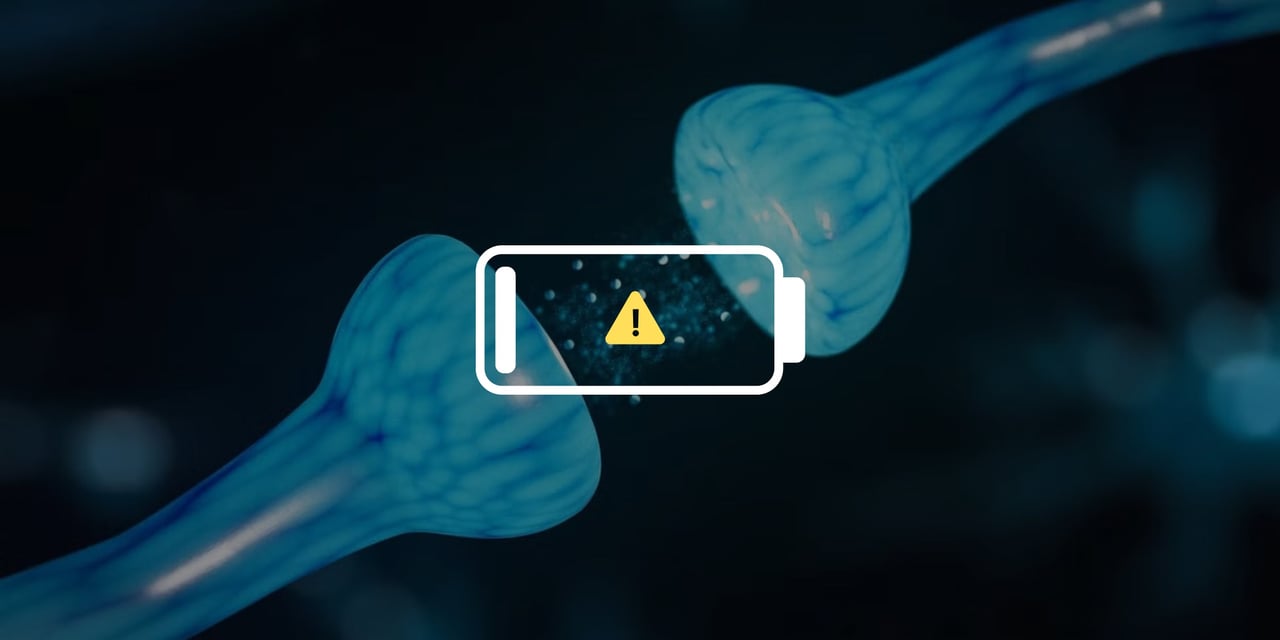 a synapse between two neurons with neurotransmitters being released from one. There is a popup notification in the middle of the image showing a low battery sign.