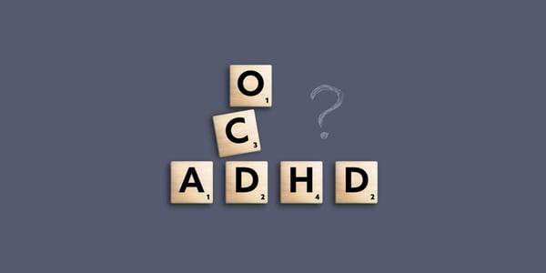 Scrabble tiles showing "ocd" and "adhd" intersecting with a question mark on the side